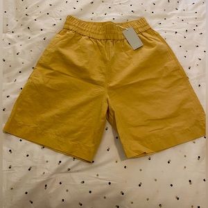 COS elastic cotton shorts in yellow
